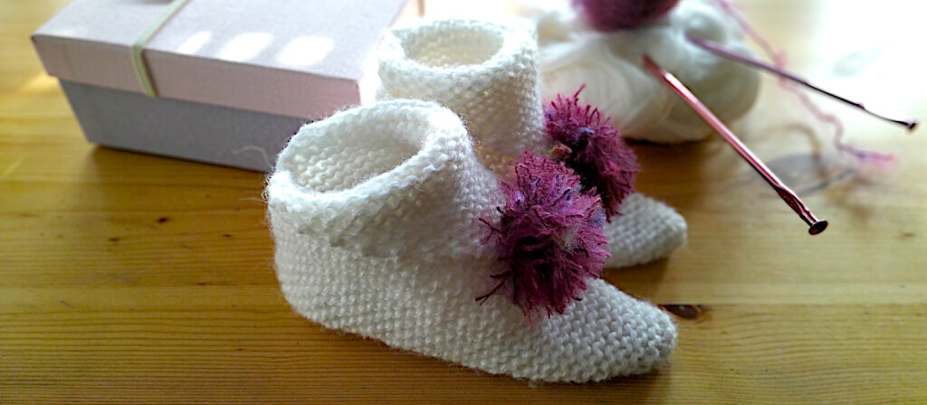 knit origami booties with a pompom
